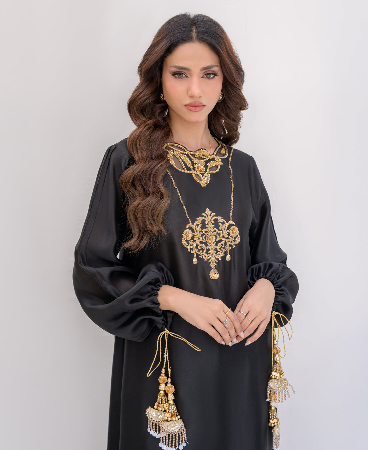 black silk two-piece evening outfit with gold tassel on sleeves