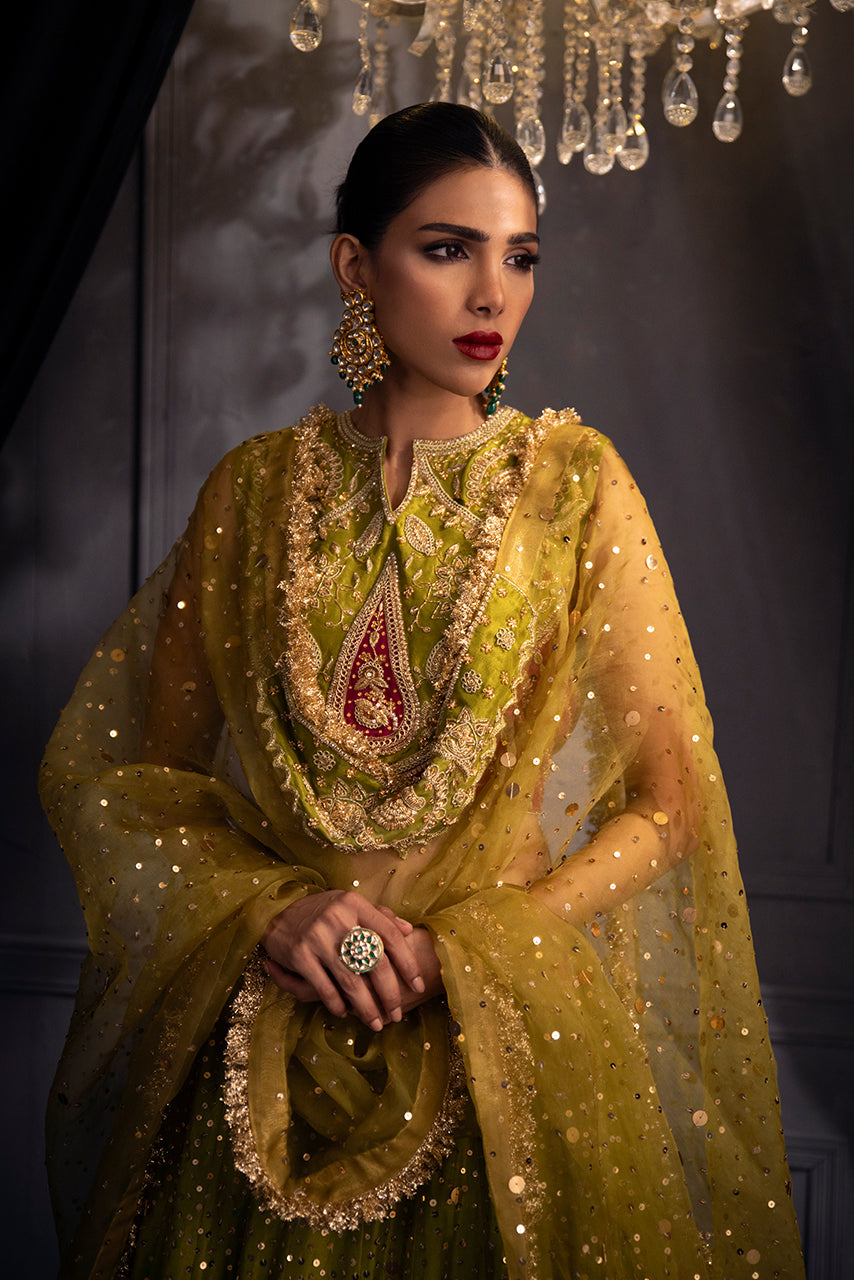 Zohra olive-gold bridal couture lehenga with a hand-embellished raw silk choli, embroidered paisley motifs, and a flowing organza dupatta with a heritage-style kiran border.