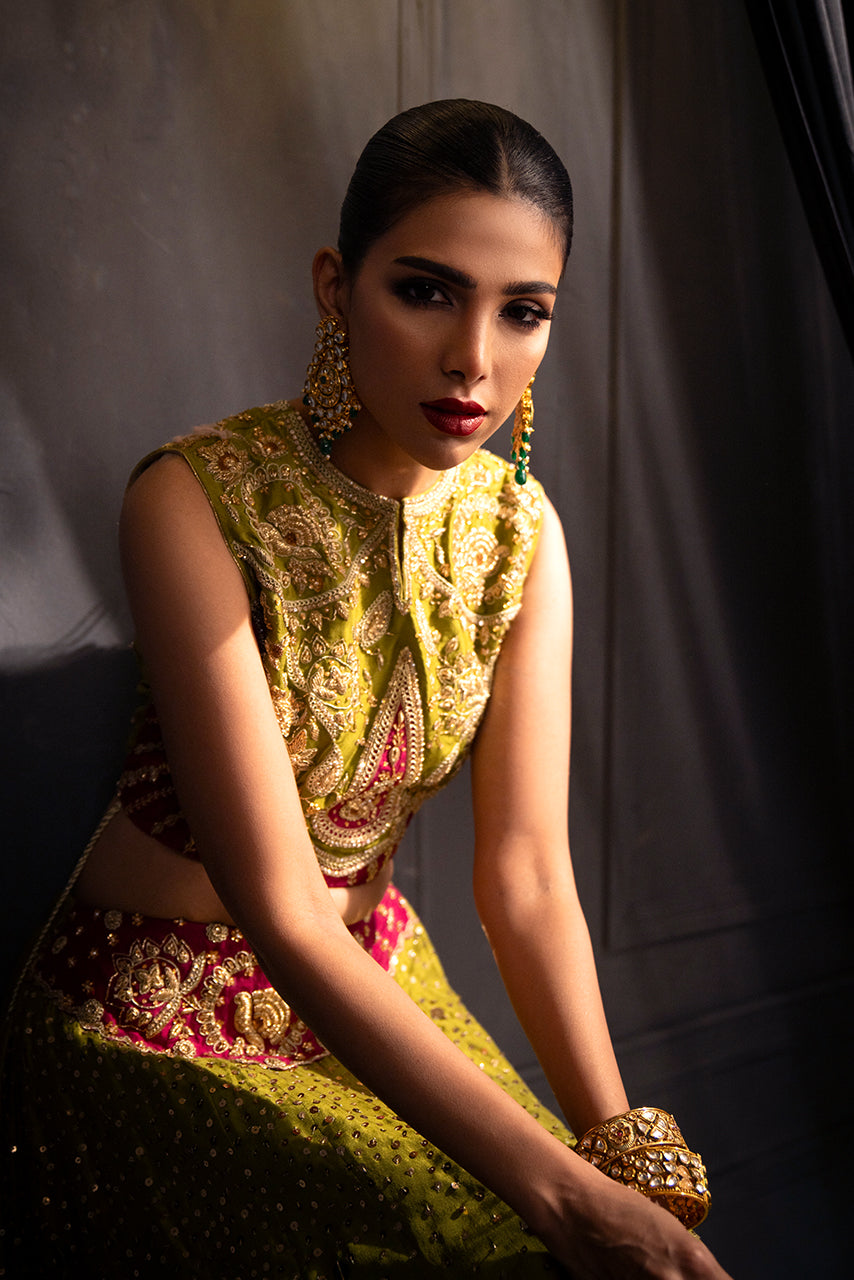 Zohra-handcrafted bridal blouse and lehnga with intricate embroidery, tassel accents, and couture craftsmanship with patch of hot pink emboridered motifs.