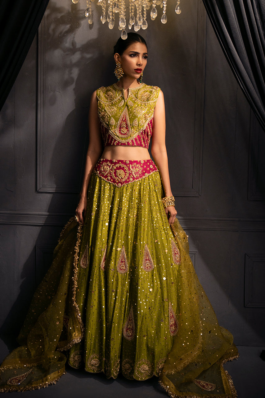 The Zohra luxury bridal ensemble is in olive gold with a zardozi-embroidered blouse, voluminous lehenga skirt, and delicately embellished dupatta.