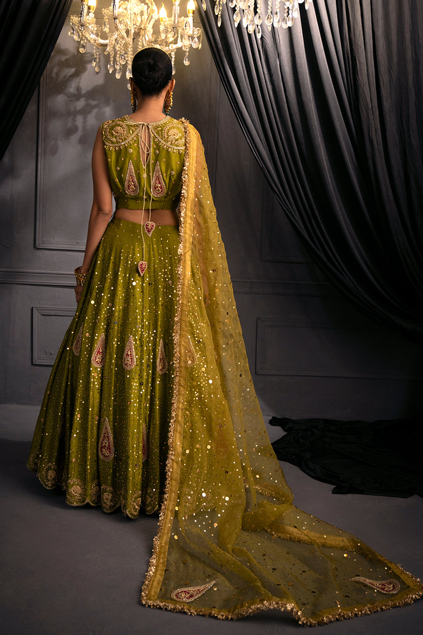 Zohra bridal designer, showcases a lehenga with an embroidered blouse back, flowing silhouette, and embellished dupatta.