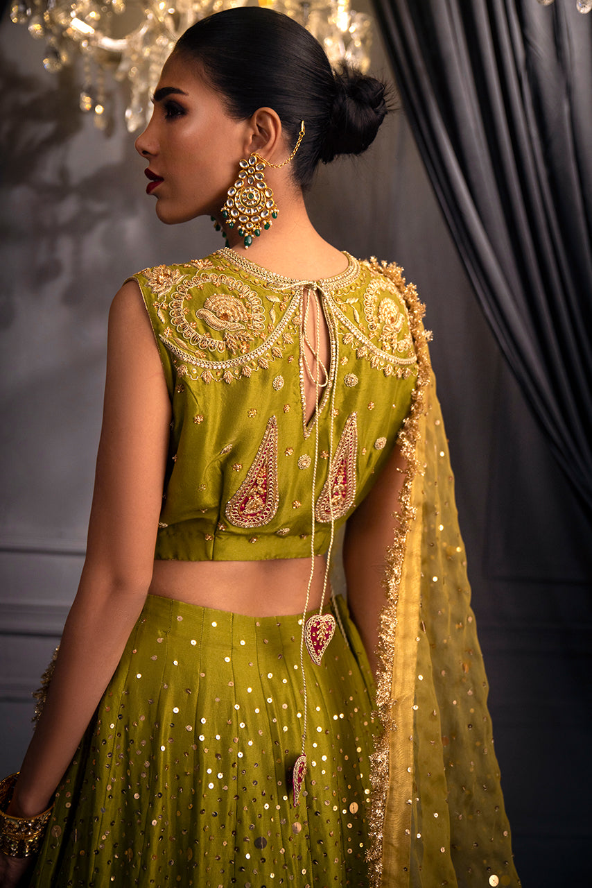 Zohra couture lehenga highlighting the intricately embroidered blouse back, fluid lehenga silhouette, and cascading embellished dupatta trail designed for luxury bridal occasions
