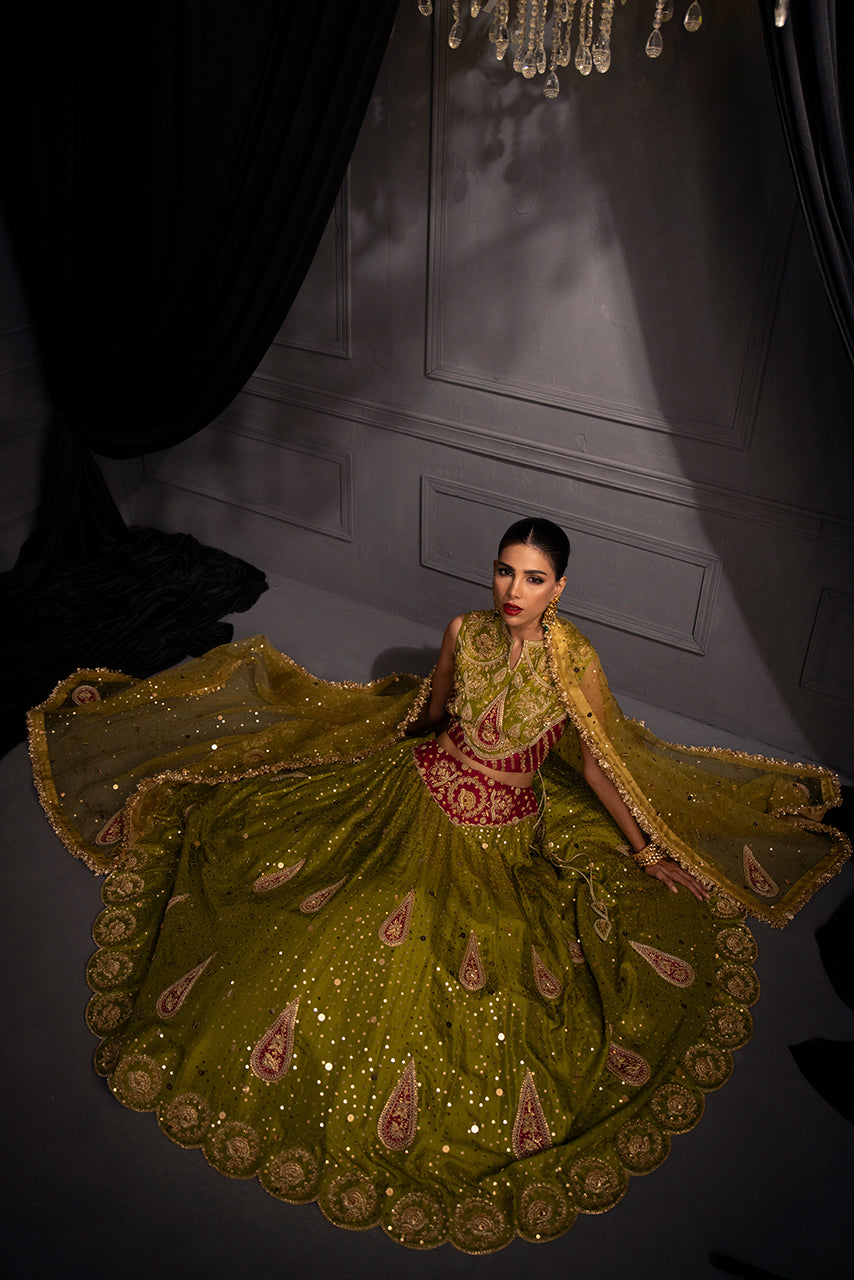 Zohra bridal designer lehenga displayed in a dramatic circular flare, revealing handcrafted paisley motifs, intricate border artistry, and radiant embellishments that embody modern heirloom couture.