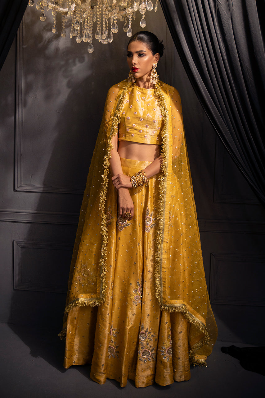 Zarmina mustard-yellow bridal designer lehenga with intricate embellishments and embroidered dupatta with heritage-style kiran traditional and modern ensemble.