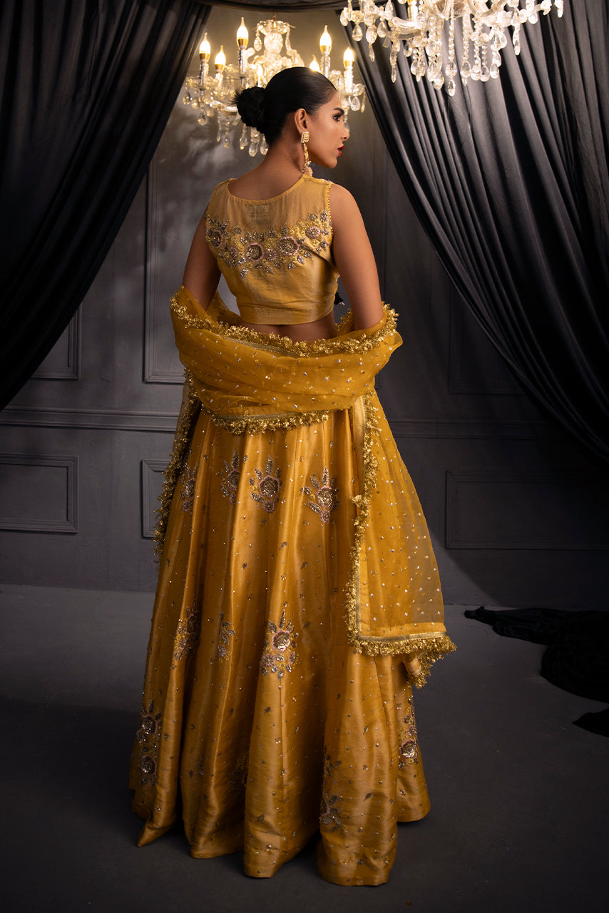 Designer mustard bridal lehenga with embroidered choli, flowing silhouette and embellished dupatta