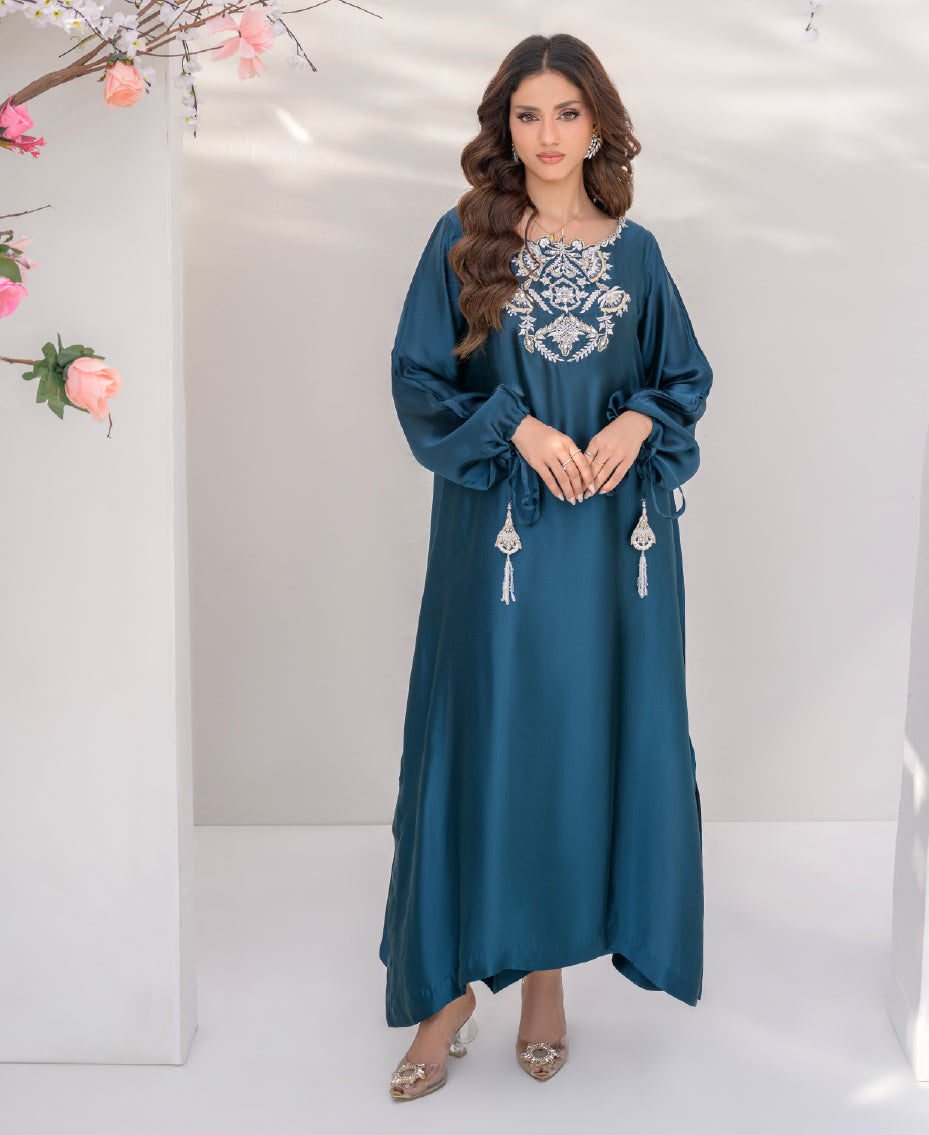 Teal sheesha silk long shirt with gold kora dabka embroidery on neckline, paired with wide-leg pants, featuring pearl and gold tassels for a luxurious festive look.